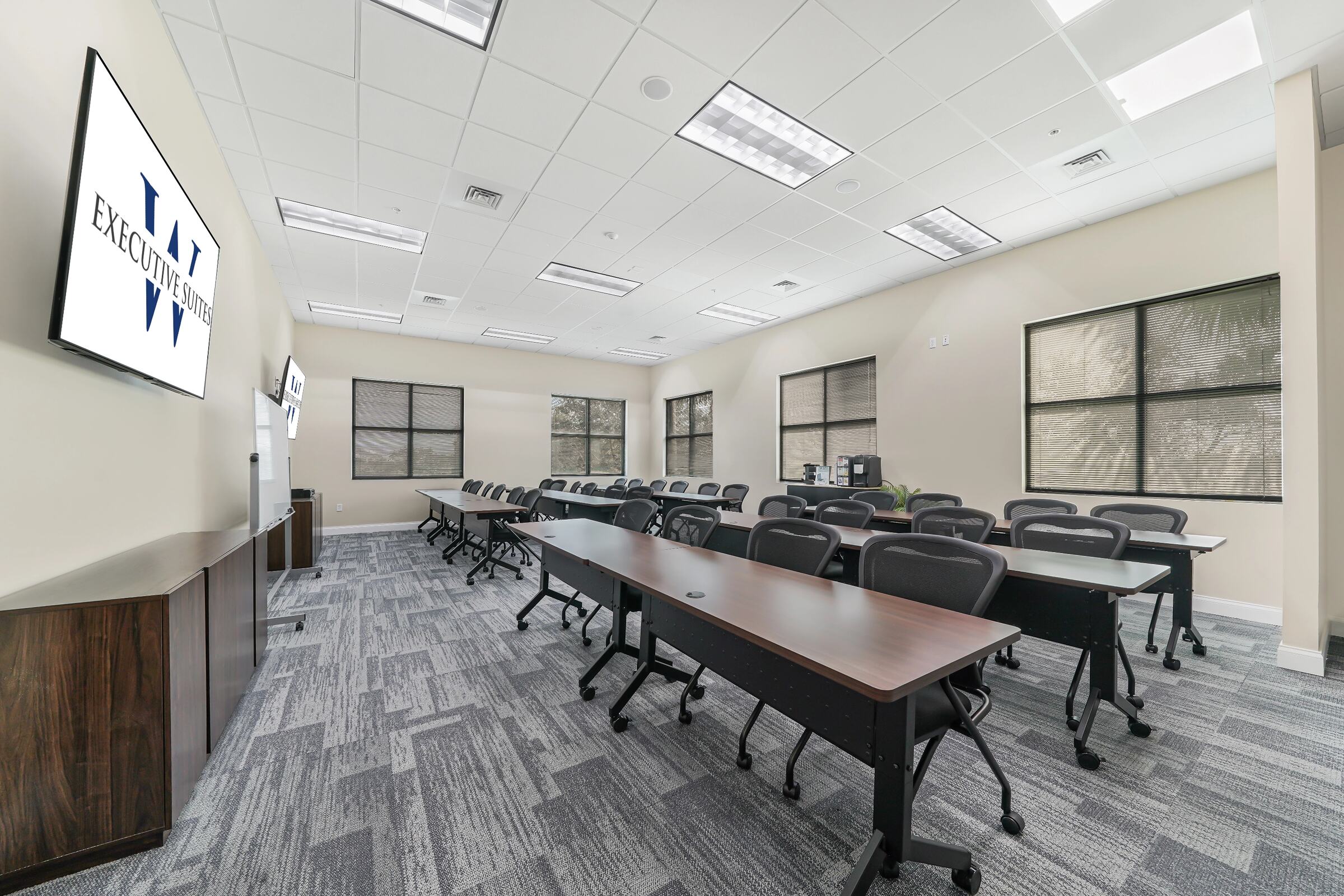 Training room with long tables and chairs at W Executive Suites St. Lucie West