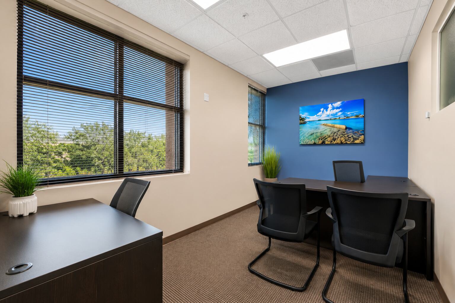 Furnished one-desk private office with a large window at W Executive Suites St. Lucie West
