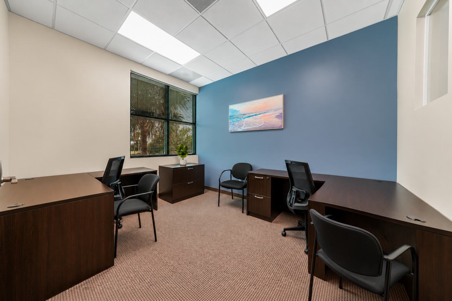 Furnished multi-desk private office with a window at W Executive Suites St. Lucie West